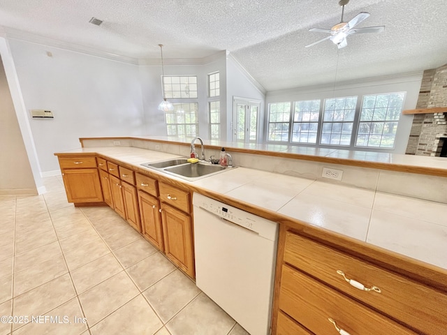 kitchen with a ceiling fan, a sink, a textured ceiling, white dishwasher, and crown molding