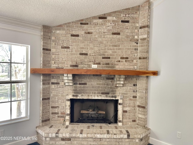 details featuring a brick fireplace and a textured ceiling