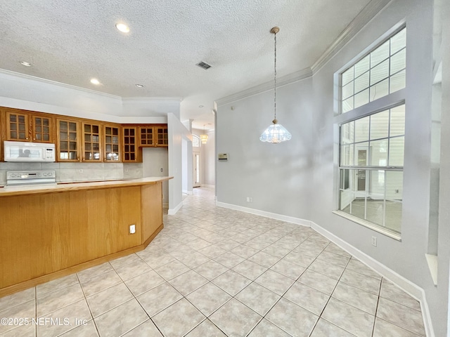 kitchen with white microwave, visible vents, range with electric cooktop, light countertops, and crown molding