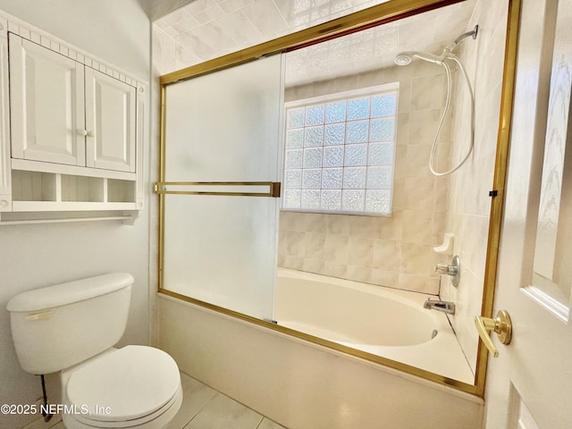 full bath with tile patterned flooring, toilet, and shower / bath combination with glass door