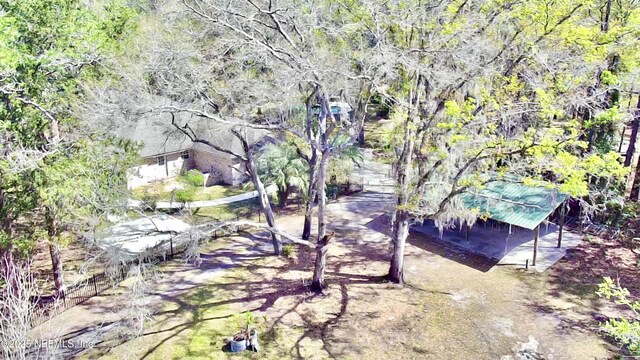 birds eye view of property featuring a wooded view