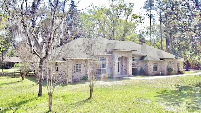 french country style house with a front yard and fence