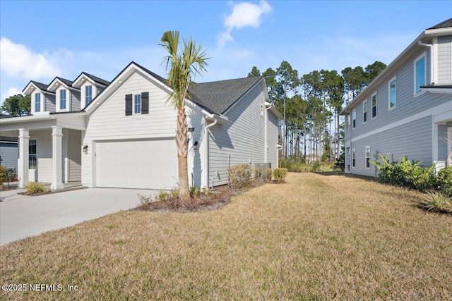 view of home's exterior featuring a garage, concrete driveway, and a yard