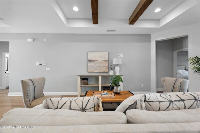 living room featuring recessed lighting, baseboards, beam ceiling, and wood finished floors