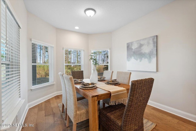 dining room featuring recessed lighting, baseboards, and wood finished floors