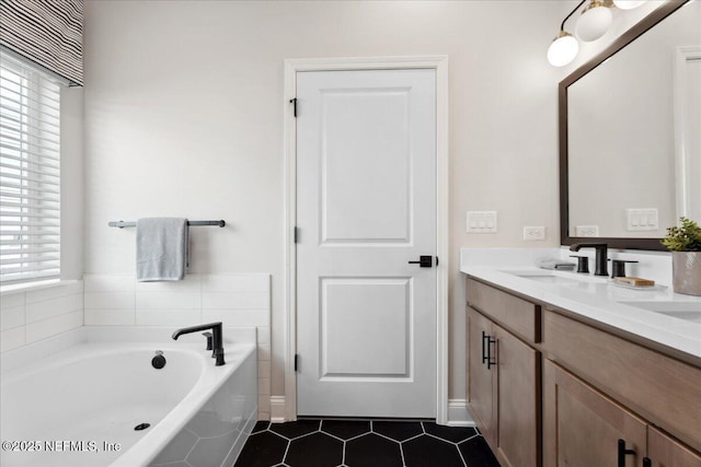 full bathroom featuring a bath, vanity, and tile patterned flooring