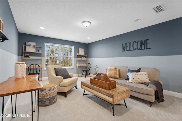 carpeted living area featuring recessed lighting, visible vents, baseboards, and a textured ceiling