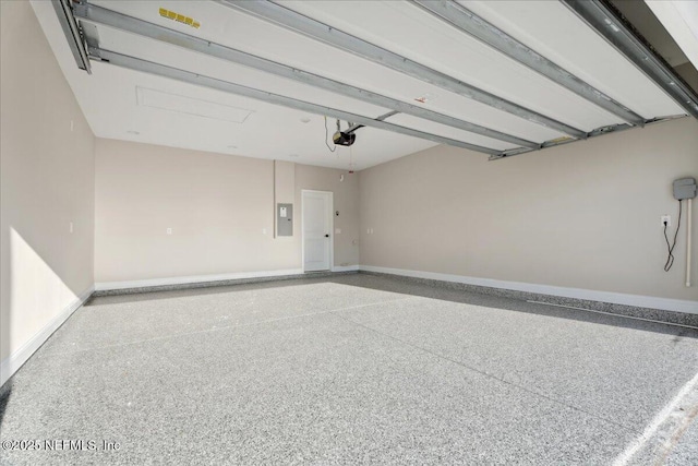 garage featuring electric panel, baseboards, and a garage door opener