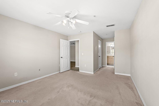 7800 Point Meadows Dr Unit 736, Jacksonville, FL 32256 - unfurnished bedroom with visible vents, baseboards, light carpet, ensuite bath, and a ceiling fan