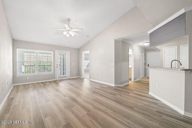 7800 Point Meadows Dr Unit 736, Jacksonville, FL 32256 - unfurnished living room featuring light wood-type flooring, baseboards, crown molding, lofted ceiling, and ceiling fan