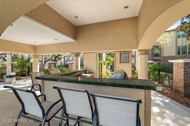 7800 Point Meadows Dr Unit 736, Jacksonville, FL 32256 - view of patio featuring outdoor wet bar and fence