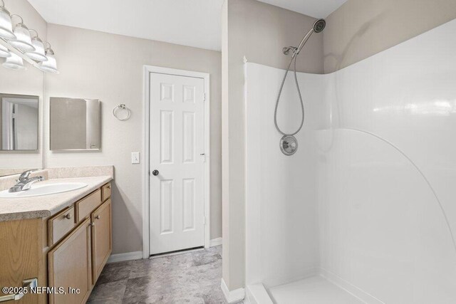 7800 Point Meadows Dr Unit 736, Jacksonville, FL 32256 - bathroom featuring baseboards, walk in shower, and vanity