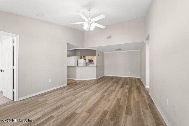 7800 Point Meadows Dr Unit 736, Jacksonville, FL 32256 - unfurnished living room featuring visible vents, baseboards, ceiling fan, wood finished floors, and high vaulted ceiling