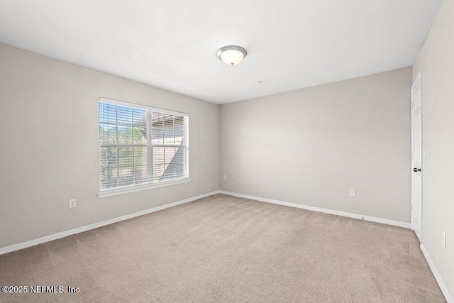 7800 Point Meadows Dr Unit 736, Jacksonville, FL 32256 - spare room featuring baseboards and light carpet