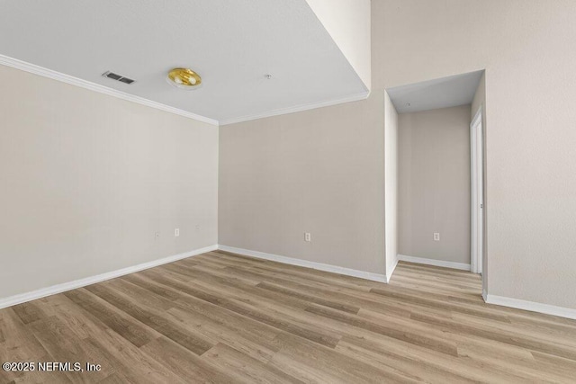 7800 Point Meadows Dr Unit 736, Jacksonville, FL 32256 - spare room with ornamental molding, baseboards, visible vents, and light wood-type flooring