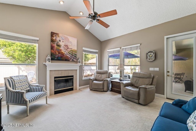 1341 Honeysuckle Dr, Saint Johns, FL 32259 - living room featuring ceiling fan, carpet floors, a tiled fireplace, plenty of natural light, and high vaulted ceiling