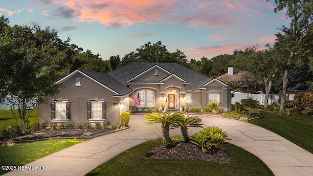 1341 Honeysuckle Dr, Saint Johns, FL 32259 - view of front facade featuring stucco siding and curved driveway