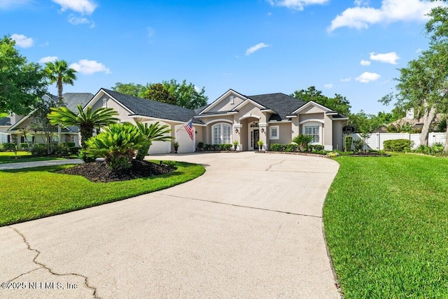 1341 Honeysuckle Dr, Saint Johns, FL 32259 - view of front of house with curved driveway, stucco siding, and an attached garage