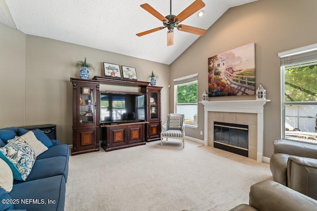 1341 Honeysuckle Dr, Saint Johns, FL 32259 - living area featuring ceiling fan, light colored carpet, a tile fireplace, high vaulted ceiling, and baseboards