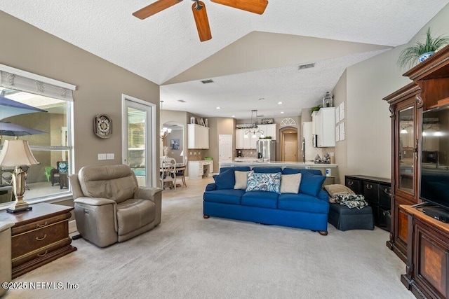 1341 Honeysuckle Dr, Saint Johns, FL 32259 - living area featuring ceiling fan, light carpet, vaulted ceiling, a textured ceiling, and a chandelier