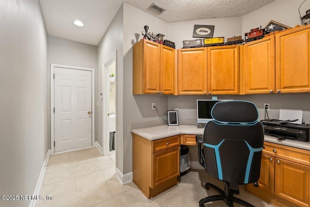 1341 Honeysuckle Dr, Saint Johns, FL 32259 - office space with built in study area, light tile patterned floors, baseboards, and a textured ceiling
