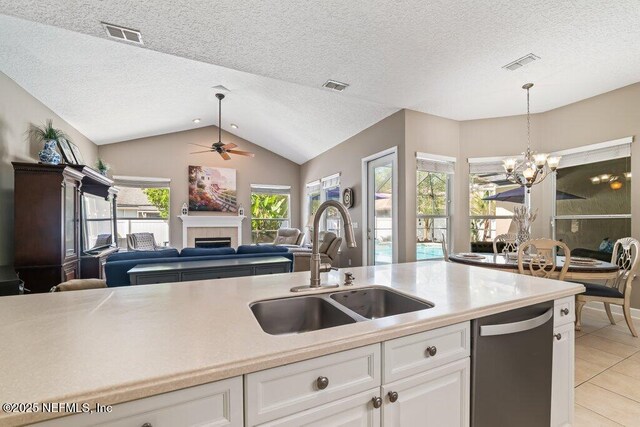 1341 Honeysuckle Dr, Saint Johns, FL 32259 - kitchen featuring dishwasher, a sink, lofted ceiling, open floor plan, and light tile patterned floors