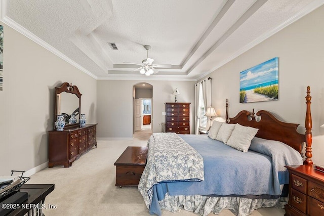 1341 Honeysuckle Dr, Saint Johns, FL 32259 - bedroom featuring a tray ceiling, light colored carpet, arched walkways, baseboards, and crown molding