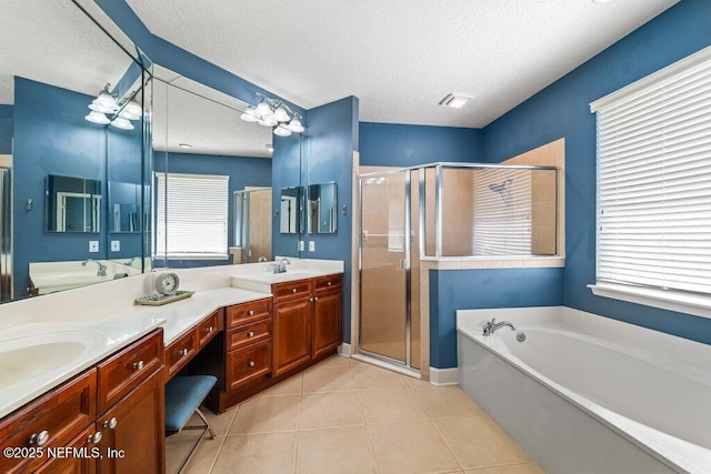 1341 Honeysuckle Dr, Saint Johns, FL 32259 - bathroom featuring a textured ceiling, a garden tub, double vanity, a shower stall, and tile patterned floors