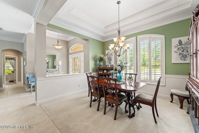 1341 Honeysuckle Dr, Saint Johns, FL 32259 - dining space featuring ornamental molding, arched walkways, a raised ceiling, a chandelier, and light tile patterned floors