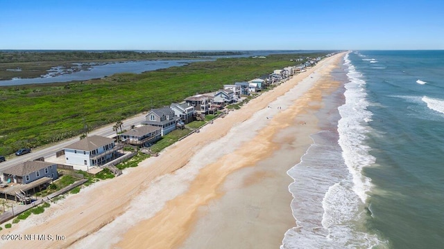 bird's eye view featuring a beach view and a water view