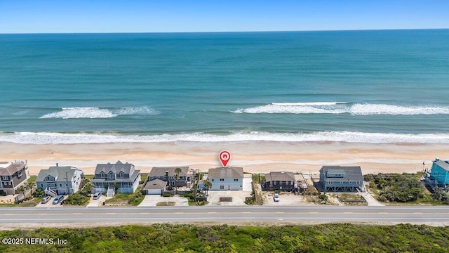 birds eye view of property with a view of the beach and a water view