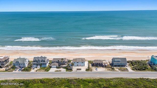 birds eye view of property featuring a view of the beach and a water view