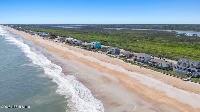 aerial view featuring a view of the beach and a water view