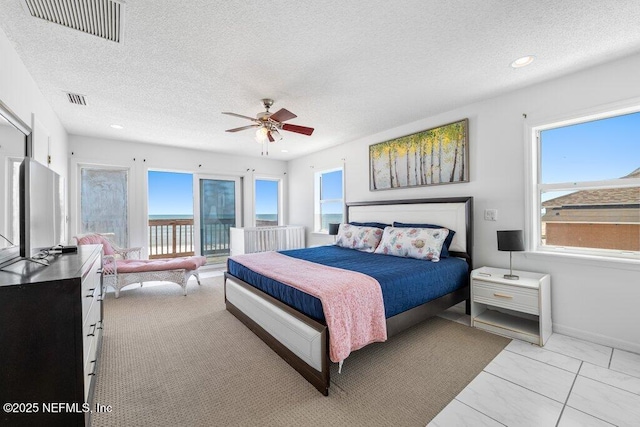 bedroom with visible vents and a textured ceiling
