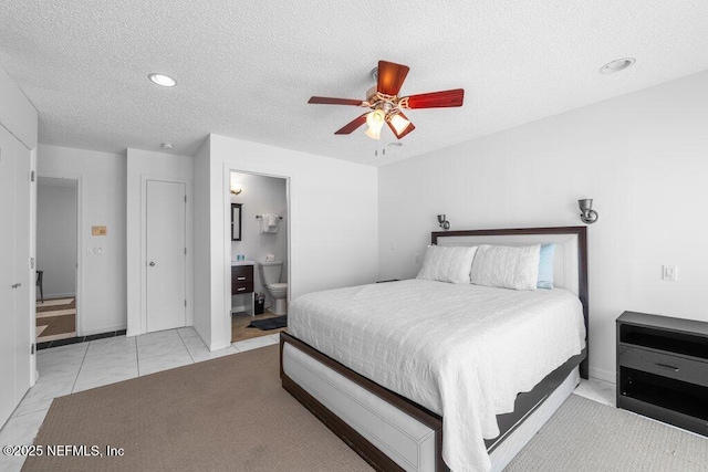 bedroom featuring connected bathroom, a ceiling fan, a textured ceiling, and recessed lighting