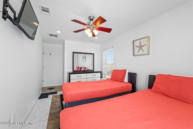 bedroom with baseboards, visible vents, a textured ceiling, and marble finish floor