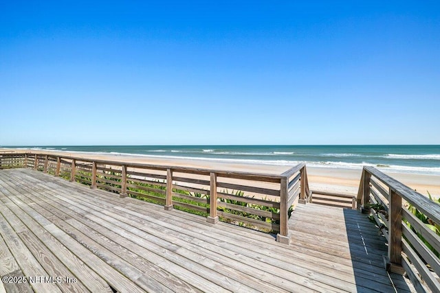 surrounding community featuring a view of the beach and a water view