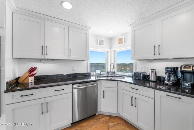 kitchen with dishwasher, a sink, a textured ceiling, and white cabinetry