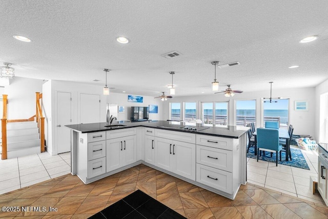 kitchen featuring dark countertops, visible vents, recessed lighting, and ceiling fan