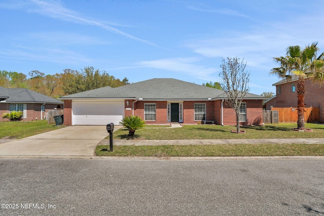 ranch-style house with driveway, brick siding, a front yard, and fence