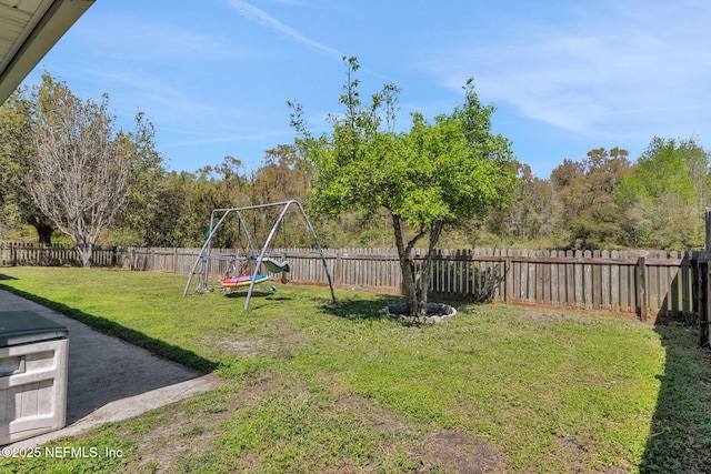 view of yard featuring a playground and a fenced backyard