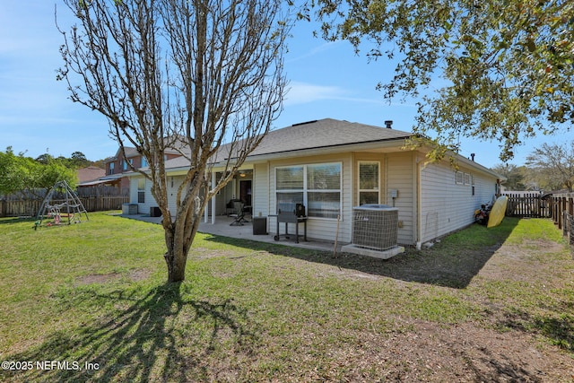 back of house featuring a fenced backyard, a lawn, cooling unit, and a patio