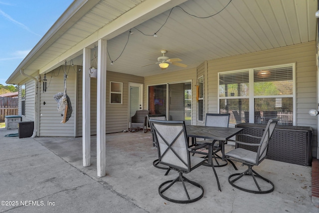 view of patio / terrace featuring outdoor dining space, fence, and ceiling fan