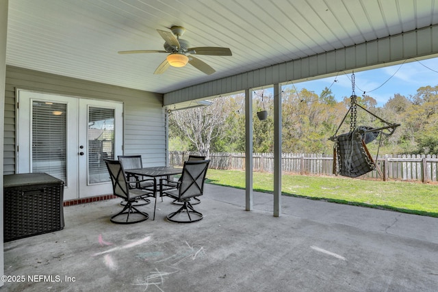 unfurnished sunroom featuring ceiling fan