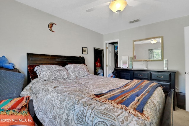 bedroom with visible vents, a ceiling fan, and carpet