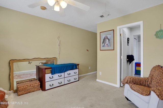 carpeted bedroom featuring visible vents, baseboards, and ceiling fan