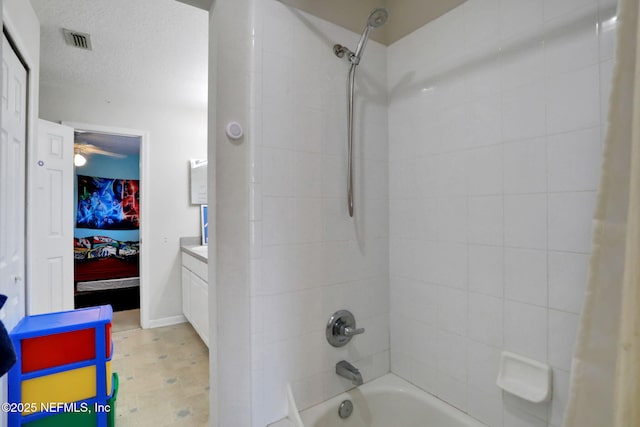 full bath featuring visible vents, shower / tub combo with curtain, vanity, and a textured ceiling