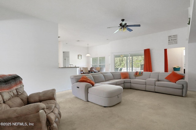 carpeted living room featuring ceiling fan