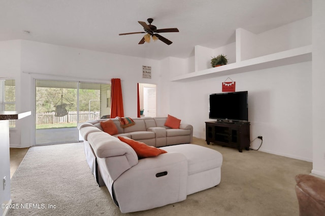 carpeted living room with a ceiling fan