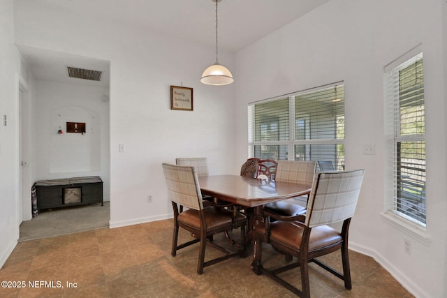 dining room featuring visible vents and baseboards